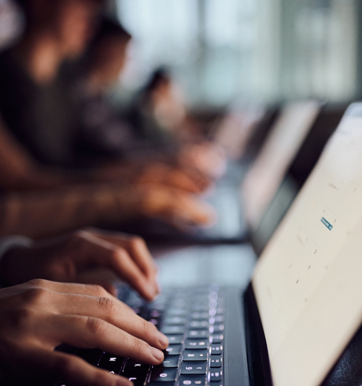 A close-up of hands on a computer keyboard