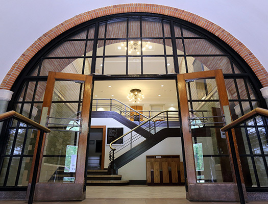 A large glass door with a staircase leading to the entrance