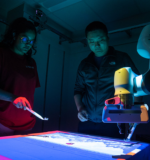 Two people looking at a machine