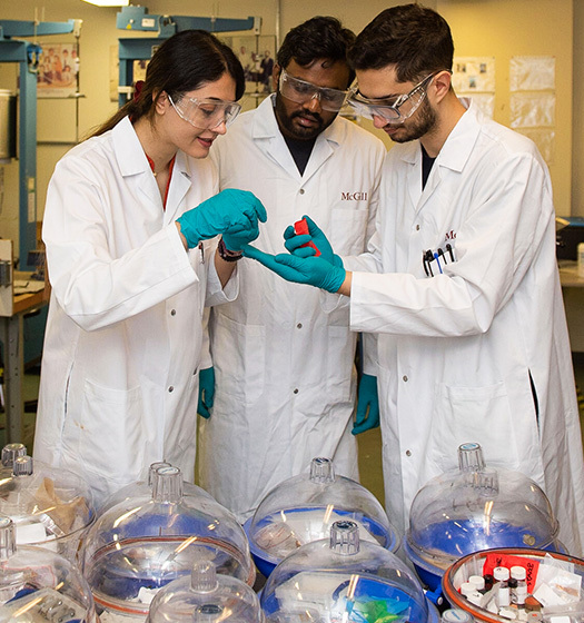 A group of people wearing white lab coats and gloves