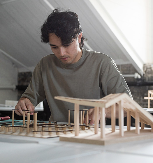 A person working on a model of a building