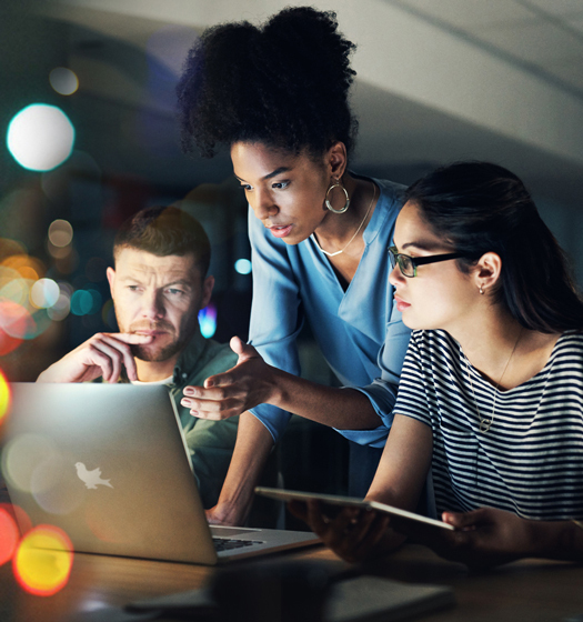 A group of people looking at a computer