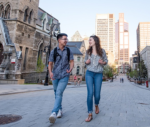 Male and female student walking on McTavish street.